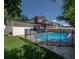 Fenced in backyard swimming pool with diving board, slide, and deck at 3212 W Arch St, Tampa, FL 33607