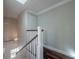 Staircase with hardwood treads and white risers leads to the home's upper level under a skylight at 3212 W Arch St, Tampa, FL 33607