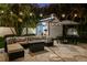 Charming outdoor retreat featuring a cozy lounge area, outdoor dining, and a charming pool house, all set within a beautifully landscaped yard at 3505 W Kensington Ave, Tampa, FL 33629