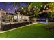 A manicured backyard featuring a luxurious outdoor seating area, pool, and lush lawn at 3505 W Kensington Ave, Tampa, FL 33629