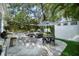 A spacious backyard with outdoor seating and dining area, ideal for enjoying the outdoors in style at 3505 W Kensington Ave, Tampa, FL 33629