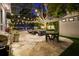 Beautiful backyard patio with outdoor seating, a dining area, a barbecue, and lush greenery, perfect for relaxation and entertainment at 3505 W Kensington Ave, Tampa, FL 33629