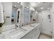 Beautiful bathroom featuring marble countertops, double sinks, and a glass-enclosed shower at 3505 W Kensington Ave, Tampa, FL 33629