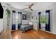 Bright bedroom featuring a ceiling fan, hardwood floors, two windows and closet at 3505 W Kensington Ave, Tampa, FL 33629