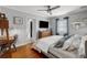 Comfortable bedroom with hardwood floors, a ceiling fan, and modern decor at 3505 W Kensington Ave, Tampa, FL 33629