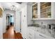 Charming butler's pantry featuring white cabinets, marble countertops, and glass display shelves at 3505 W Kensington Ave, Tampa, FL 33629