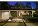 Inviting single-story home with a charming entrance, a decorative fountain, and manicured landscaping at 3505 W Kensington Ave, Tampa, FL 33629