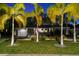 Charming single-story home featuring a well-manicured lawn and decorative palm trees in the beautifully landscaped front yard at 3505 W Kensington Ave, Tampa, FL 33629