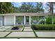 Close up of a charming front porch, black front door, and decorative plants at 3505 W Kensington Ave, Tampa, FL 33629