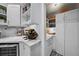 Butler's pantry featuring wine storage, marble counters and white cabinetry at 3505 W Kensington Ave, Tampa, FL 33629