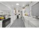 Bright white kitchen with stainless appliances, wine cooler, and unique tile flooring at 3505 W Kensington Ave, Tampa, FL 33629