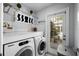 Well-equipped laundry room with a washer, dryer, and ample counter space at 3505 W Kensington Ave, Tampa, FL 33629