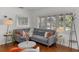 Cozy living room with hardwood floors, large windows with plantation shutters, and stylish furnishings at 3505 W Kensington Ave, Tampa, FL 33629