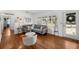 A bright, open living room featuring hardwood floors, large windows, and modern furnishings at 3505 W Kensington Ave, Tampa, FL 33629