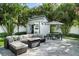 This patio showcases a cozy outdoor lounge area, perfect for entertaining guests in a tropical backyard setting at 3505 W Kensington Ave, Tampa, FL 33629