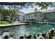 Swimming pool in the backyard of a home, bordered by pavers, with a waterfall feature at 3505 W Kensington Ave, Tampa, FL 33629