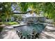 Tranquil pool area surrounded by lush greenery and featuring black and white decorative balls at 3505 W Kensington Ave, Tampa, FL 33629