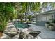 Inviting outdoor patio area featuring a pool, cabana, and lush landscaping at 3505 W Kensington Ave, Tampa, FL 33629