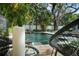 Serene pool area featuring lush landscaping and decorative black and white balls at 3505 W Kensington Ave, Tampa, FL 33629