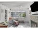 Bright sunroom with cozy seating, fireplace, and large windows at 3505 W Kensington Ave, Tampa, FL 33629