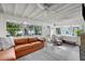 Bright sunroom with beamed ceiling, cozy seating and large windows at 3505 W Kensington Ave, Tampa, FL 33629
