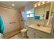 An accessible bathroom features a tiled shower, grab bars, and a sink with cabinet at 3890 Mainlands N Blvd, Pinellas Park, FL 33782