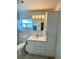 This bathroom has a vanity with storage, a toilet, and a shower with a curtain at 3890 Mainlands N Blvd, Pinellas Park, FL 33782