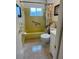 Bathroom features a yellow tiled shower/tub and a vanity at 3890 Mainlands N Blvd, Pinellas Park, FL 33782