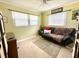 A cozy bedroom featuring a futon sofa and an abundance of natural light at 3890 Mainlands N Blvd, Pinellas Park, FL 33782