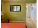 View from the primary bedroom into the en suite bathroom with ample vanity storage at 3890 Mainlands N Blvd, Pinellas Park, FL 33782
