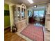 Dining area with glass display cabinet and an adjacent view to the dining table at 3890 Mainlands N Blvd, Pinellas Park, FL 33782