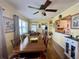 Bright dining room with hardwood floors, ceiling fan, and view of kitchen at 3890 Mainlands N Blvd, Pinellas Park, FL 33782