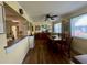 This dining room features wood floors, a bar, and ample natural light from the large windows at 3890 Mainlands N Blvd, Pinellas Park, FL 33782