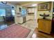Bright kitchen with white cabinets, modern appliances, and an open layout with eat-in area at 3890 Mainlands N Blvd, Pinellas Park, FL 33782