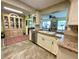 Bright kitchen featuring granite countertops, tile floors, modern appliances and open view to the dining area at 3890 Mainlands N Blvd, Pinellas Park, FL 33782