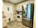 Modern kitchen features stainless appliances, light cabinetry, and convenient access door at 3890 Mainlands N Blvd, Pinellas Park, FL 33782
