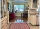 Cozy kitchen with a view to the dining area, neutral cabinets, and a decorative rug at 3890 Mainlands N Blvd, Pinellas Park, FL 33782