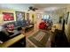 Spacious living room featuring hardwood floors, large sectional sofa and ample natural light at 3890 Mainlands N Blvd, Pinellas Park, FL 33782