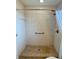 A walk-in shower features neutral tile, a grab bar, and a detachable shower head at 3890 Mainlands N Blvd, Pinellas Park, FL 33782