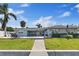 Home's backyard with lush grass, a pool, patio, and access to a dock at 3910 Doral Dr, Tampa, FL 33634