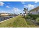 Home's backyard with lawn and dock access at 3910 Doral Dr, Tampa, FL 33634