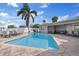 Backyard with a swimming pool surrounded by patio, along with a lounge area, dining area, and grill at 3910 Doral Dr, Tampa, FL 33634