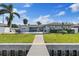 Backyard with lush grass, a pool, patio, and access to a private dock at 3910 Doral Dr, Tampa, FL 33634