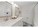 Bright bathroom featuring double sinks, quartz countertops, framed mirrors, and modern lighting fixtures at 3910 Doral Dr, Tampa, FL 33634