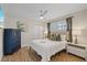 Comfortable bedroom with wood-look floors, ceiling fan, window with shutters, and a neatly made queen bed at 3910 Doral Dr, Tampa, FL 33634