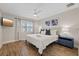 Cozy bedroom with wood floors, ceiling fan, and window with white shutters at 3910 Doral Dr, Tampa, FL 33634