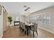 Elegant dining room with wood floors, modern light fixture, and large windows with stylish shutters at 3910 Doral Dr, Tampa, FL 33634