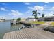 Home's backyard featuring a dock, lawn, and waterfront access at 3910 Doral Dr, Tampa, FL 33634