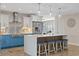 Modern kitchen with white and blue cabinetry, a large island, stainless steel appliances, and stylish pendant lights at 3910 Doral Dr, Tampa, FL 33634