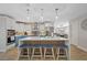 Stylish kitchen with an island, seating, stainless steel appliances, and a view into the dining room at 3910 Doral Dr, Tampa, FL 33634